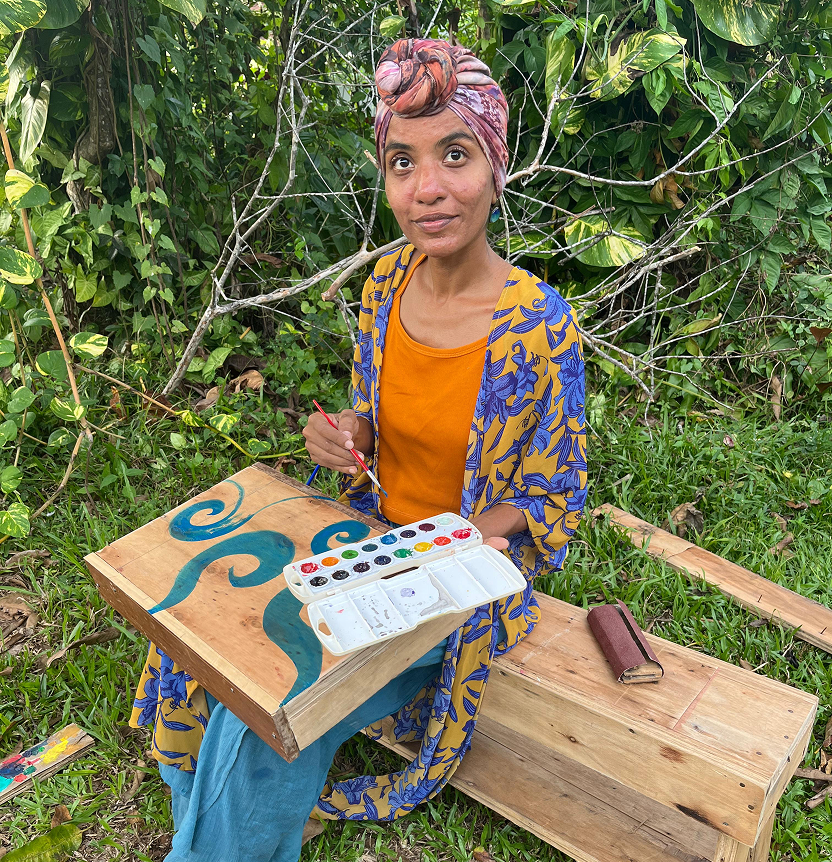 Community member painting outdoors